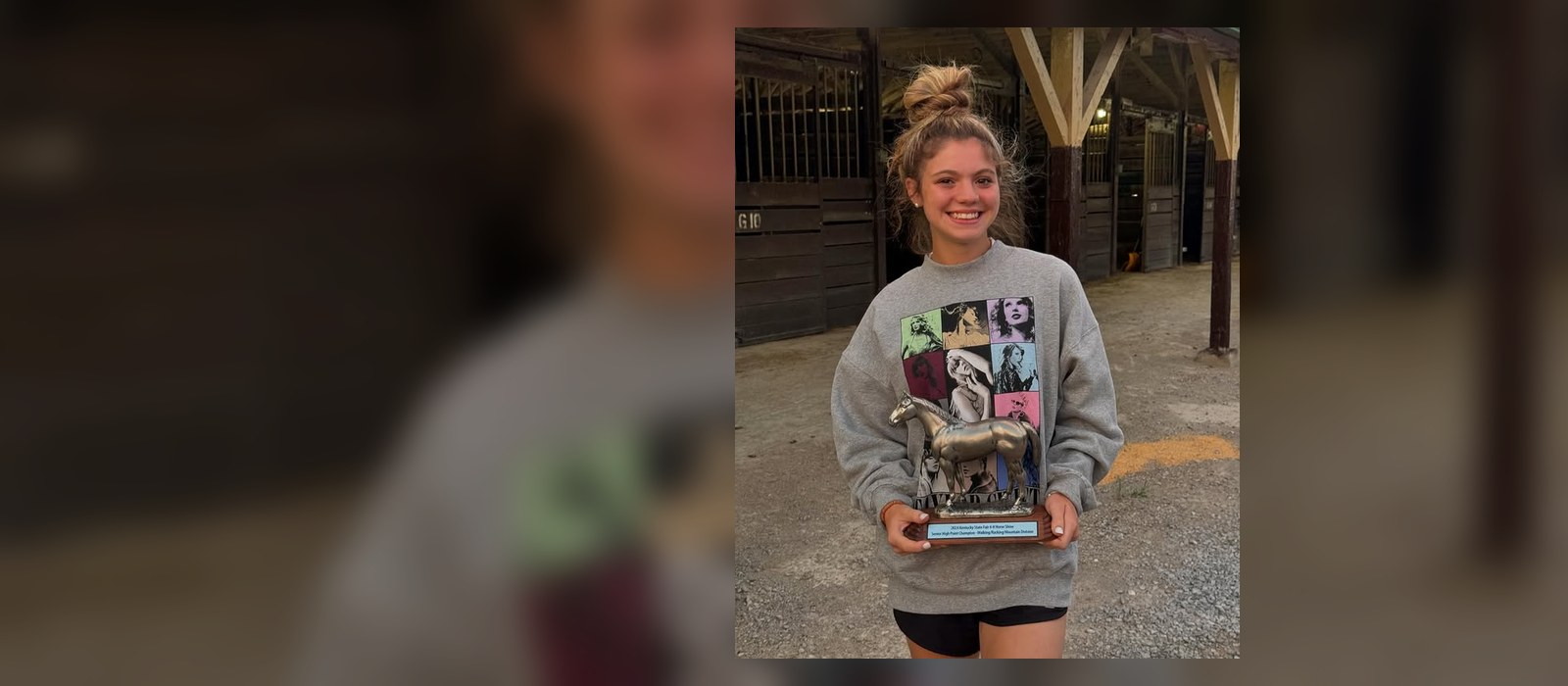 Rylee Eilerman smiles in the Setting Sun Equestrian barn aisle, holding a 2024 Kentucky State 4-H Horse Show High Point Champion trophy.